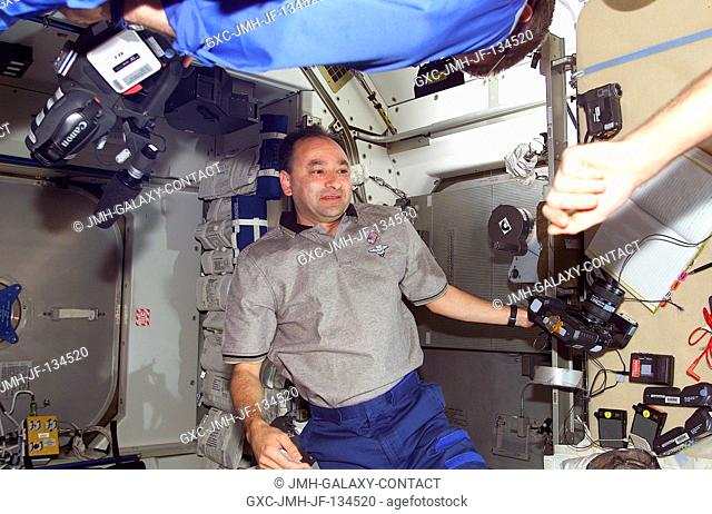 Astronaut Mark L. Polansky, STS-98 pilot, prepares to document activity on the International Space Station (ISS) with a camera soon after the STS-98 astronauts...