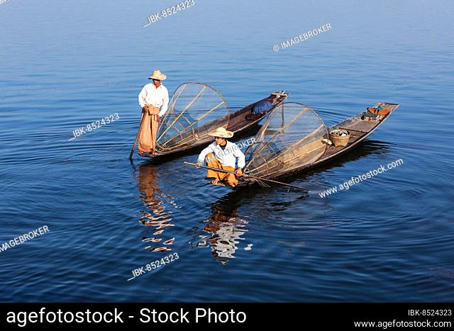 Myanmar travel attraction landmark, Traditional Burmese fishermen with fishing net at Inle lake in Myanmar famous for their distinctive one legged rowing style