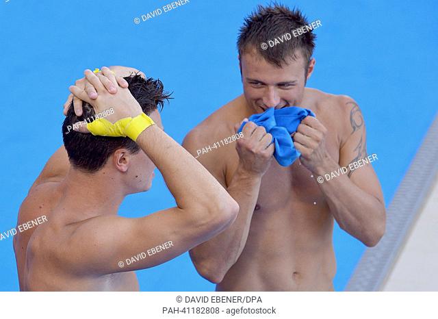 Gold medalists Patrick Hausding (L) and Sascha Klein of Germany celebrate after the men's 10m Synchro Platform diving final of the 15th FINA Swimming World...