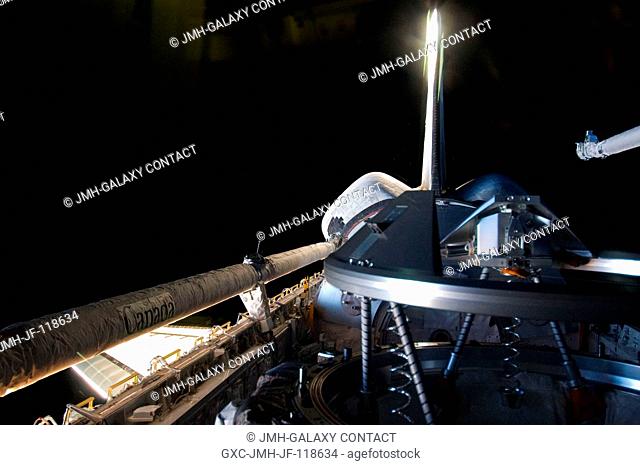 This picture of Atlantis' payload bay, focusing on the docking mechanism, was photographed by one of four STS-135 crewmembers inside the crew cabin