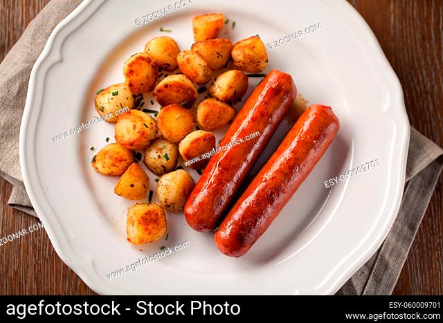 Sausages and potatoes on a plate. High quality photo