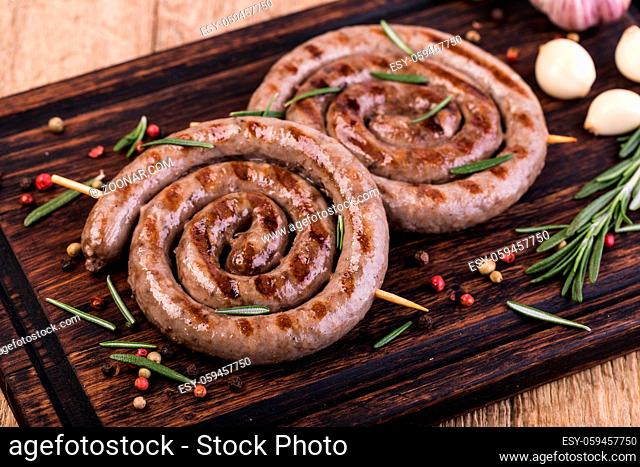 Grilled sausages on a wooden cutting board