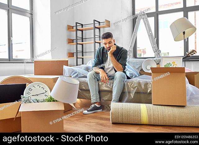 sad man with boxes moving to new home
