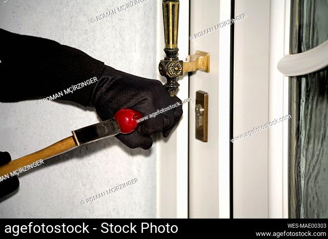 Burglary, hand with gloves on door, close-up