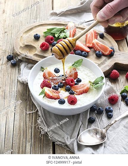 Healthy breakfast - Rice cereal or porridge with berries and honey