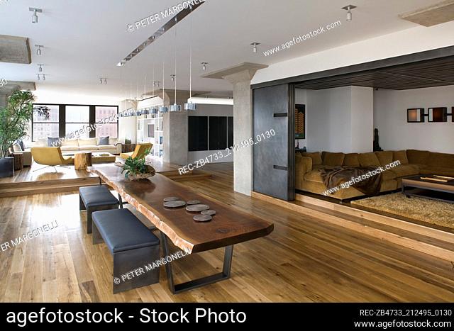 Leather bench seats at wooden table in spacious open plan room