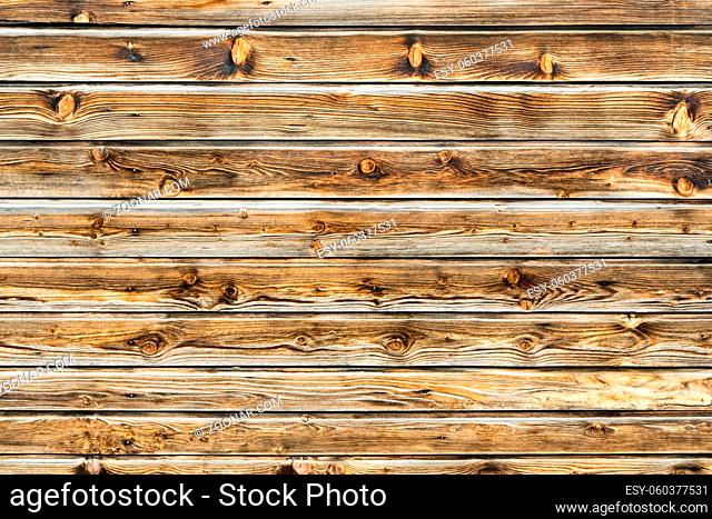 Natural brown barn wood wall. Wooden wall background design. Wood planks, boards are old with a beautiful rustic look. Timber design style