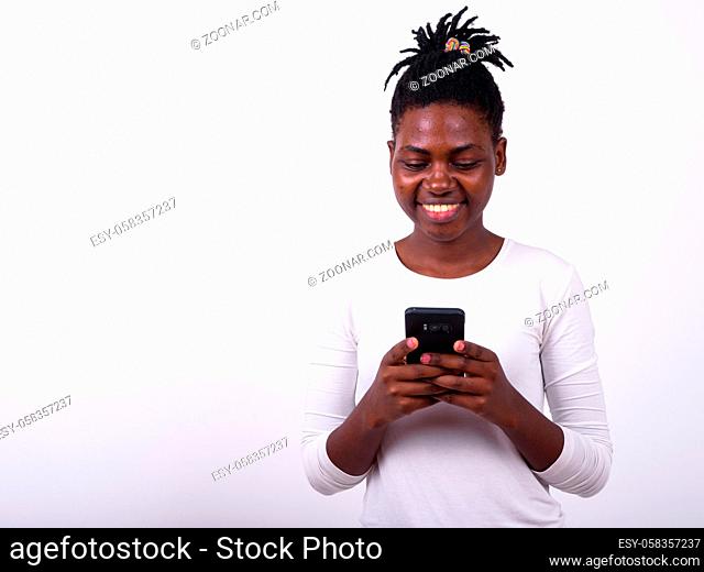 Studio shot of young beautiful African woman against white background