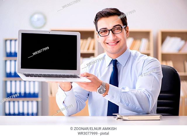 Businessman demonstrating the screen of laptop