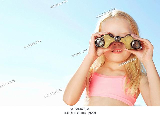 Girl looking through binoculars