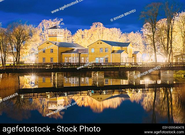 Kuressaare, Estonia. Old Traditional Yellow Wooden House In Evening Blue Hour Night