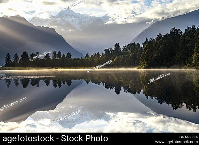 View of Mount Cook in morning light, reflection in Lake Matheson, Westland National Park, New Zealand Alps, West Coast Region, South Island, New Zealand