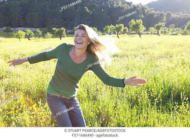 Forty something year old woman in a meadow