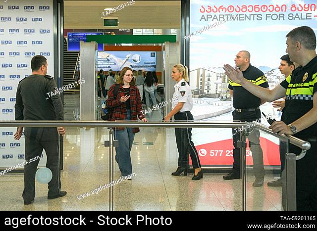 GEORGIA, TBILISI - MAY 19, 2023: A woman appears in the arrivals area at Shota Rustaveli Tbilisi International Airport where an Azimuth flight from Moscow...