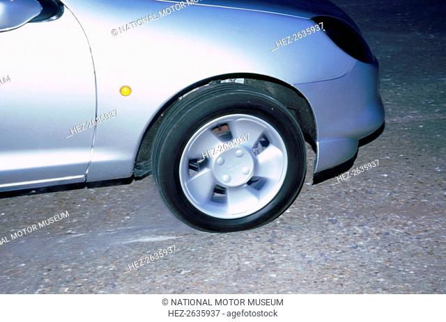 Wheel spin on 1998 Ford Puma producing smoke. Artist: Unknown