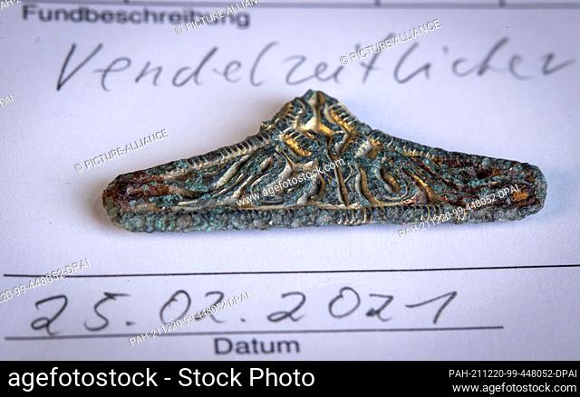 14 December 2021, Mecklenburg-Western Pomerania, Wiligrad: A Vendel Age fitting from the eighth century AD from a find near Groß Strömkendorf is on display at...