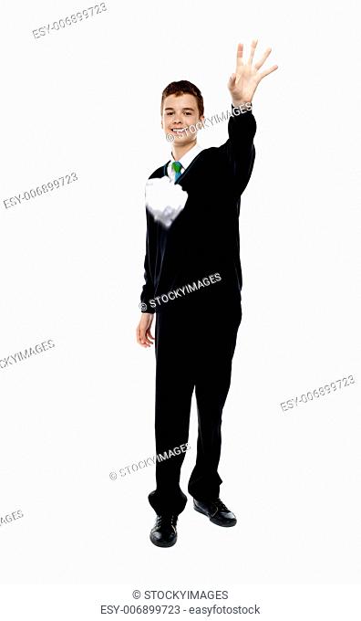 Cheerful young boy throwing paper isolated over white