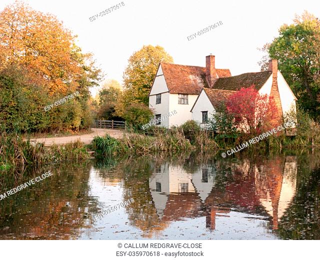willy lotts cottage at flatford mill in suffolk in autumn reflections in lake; suffolk; england; uk