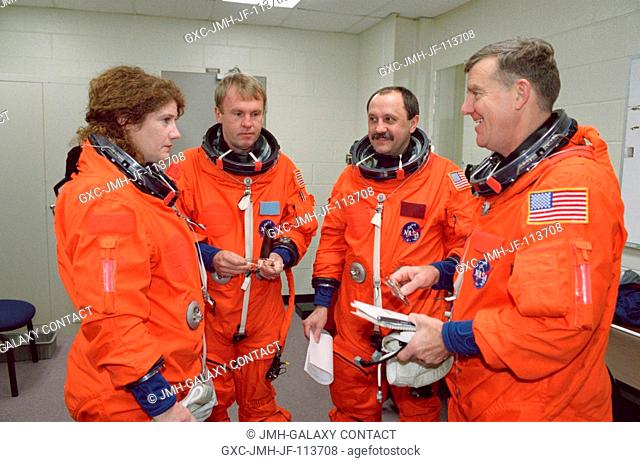 Astronaut Andrew S.W. Thomas (second left), STS-102 mission specialist, chats with the Expedition Two crew members prior to a simulation exercise in the Systems...