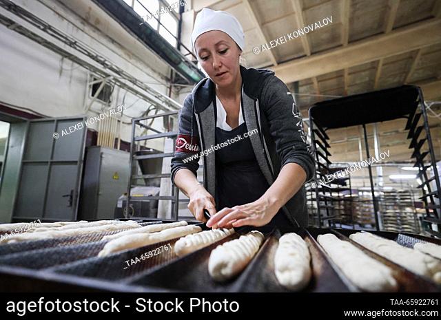 RUSSIA, ZAPOROZHYE REGION - DECEMBER 19, 2023: An employee is at work at the Berdyansk Bakery in the city of Berdyansk. The enterprise produces 8 tonnes of...
