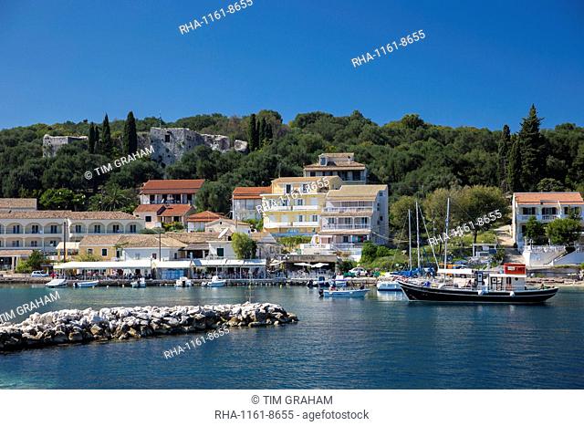 Spectacular beach resort and harbour of Kassiopi with blue sky and turquoise Ionian Sea, Corfu, Ionian Islands, Greek Islands, Greece, Europe