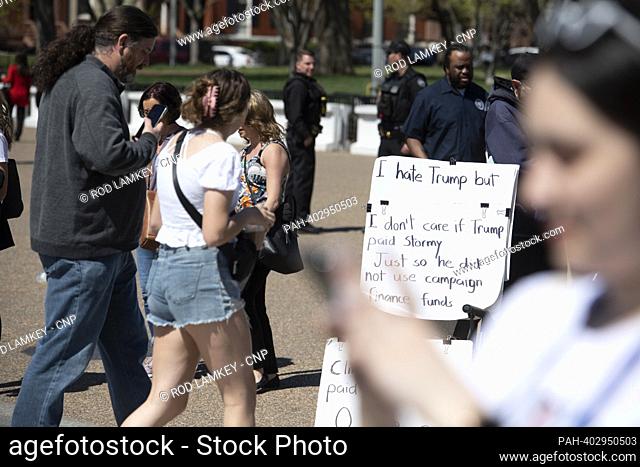 People go about their daily life while visiting outside the White House in Washington, DC, Tuesday, April 4, 2023, while former President Donald Trump is...
