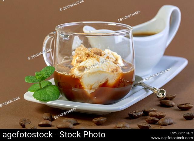 Affogato coffee. Italian dessert of ice cream, espresso and cookie crumb topping is served in a glass cup with a sprig of mint