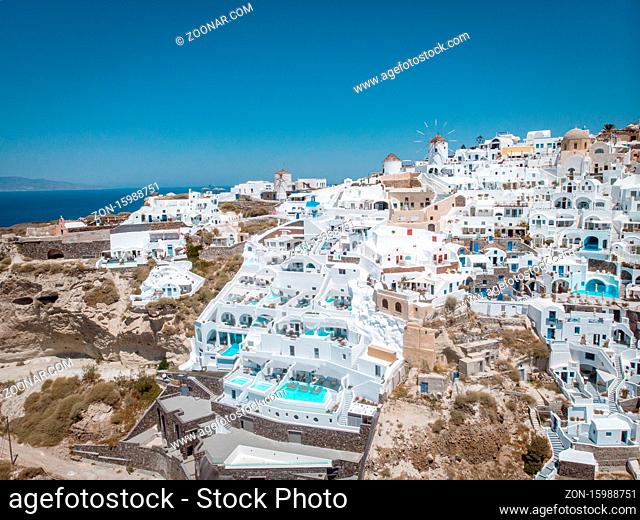 Drone view over Santorini, aerial view over the whitewashed village of Oia with luxury vacation resort with infinity pools in Santorini Greece. Europe