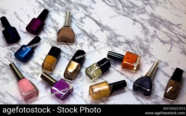 Scattered nail Polish in the beauty salon. The choice of color nail Polish for manicure or pedicure. gel Polish for manicure on a marble table