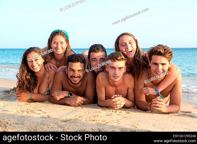 Group of happy young people at the beach