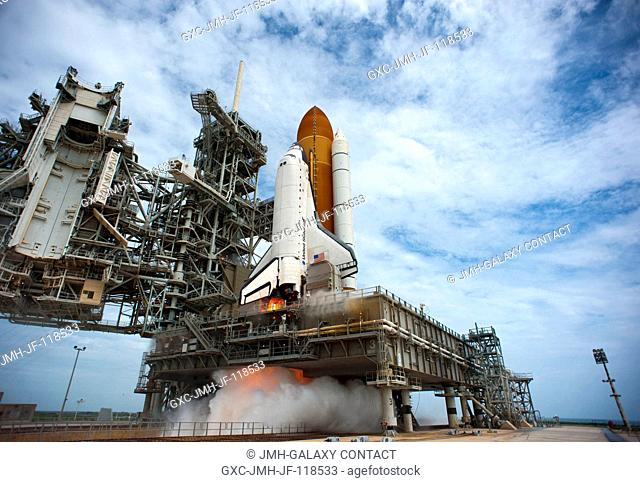 At NASA's Kennedy Space Center in Florida, space shuttle Atlantis' main engines and solid rocket boosters ignite on Launch Pad 39A leaving behind a billow of...