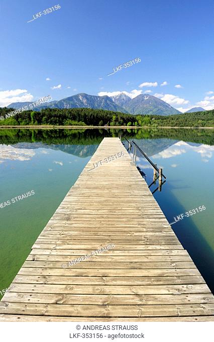 Wooden landing stage leading into lake Turnersee, Karawanken range in the background, lake Turnersee, Carinthia, Austria, Europe