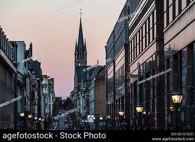 Molenbeek, Brussels Capital Region - Belgium - 11 23 2020 - The KBC bank offices and the tower of the Saint Remigius church during sunrise