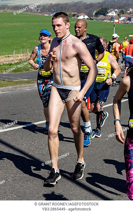 A Semi Nude Male Athlete Taking Part In The Brighton Marathon, Brighton, Sussex, UK