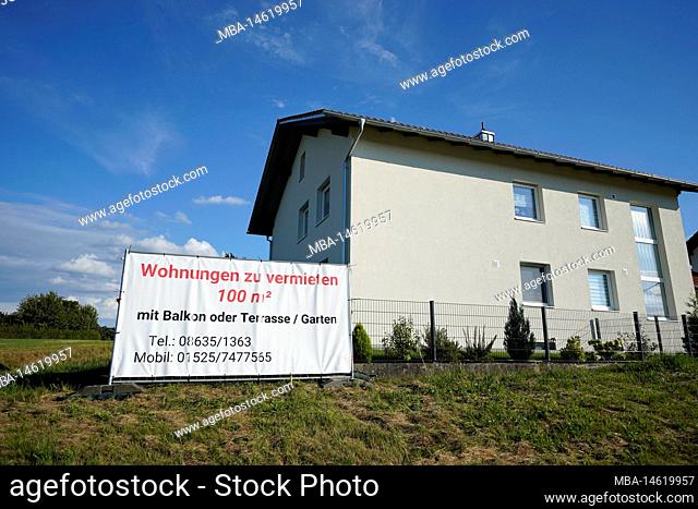 Germany, Bavaria, Upper Bavaria, Altötting district, apartment house in the countryside, in front of it a board, apartments for rent