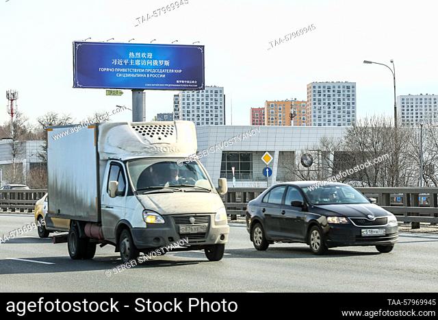 RUSSIA, MOSCOW - MARCH 20, 2023: A distant view of a bilingual billboard with a message reading ""We Warmly Welcome The Chairman of the People's Republic of...