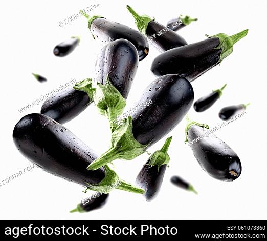 Ripe eggplants levitate on a white background