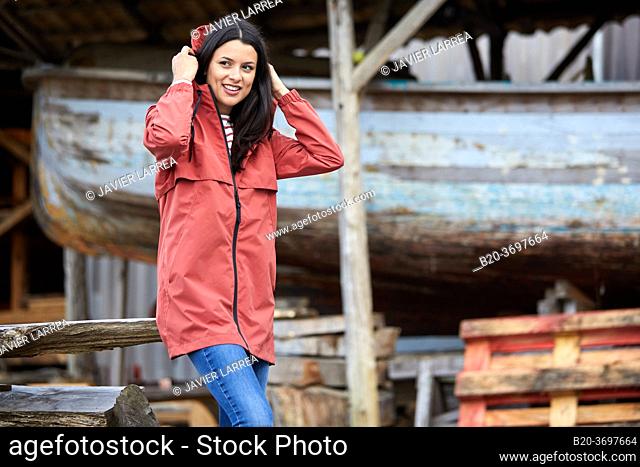 Young woman with raincoat, Pasaia, Gipuzkoa, Basque Country, Spain, Europe