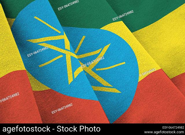 Ethiopia flag with big folds waving close up under the studio light indoors. The official symbols and colors in fabric banner