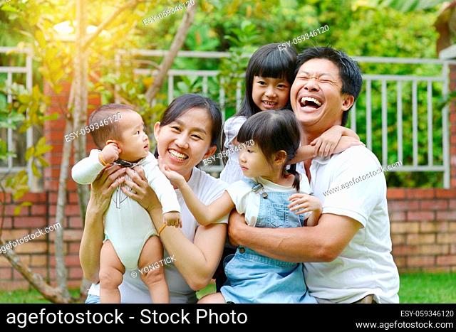 Portrait of happy asian family playing In garden.Concept of family relaxation