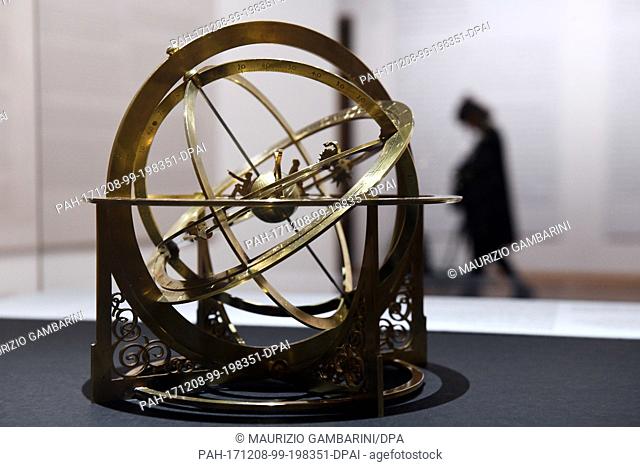 A visitor looking at a reproduction of a Medieval armillary sphere at the exhibition ""Juden, Christen und Muslime im Dialog der Wissenschaften 500-1500"" (Jews