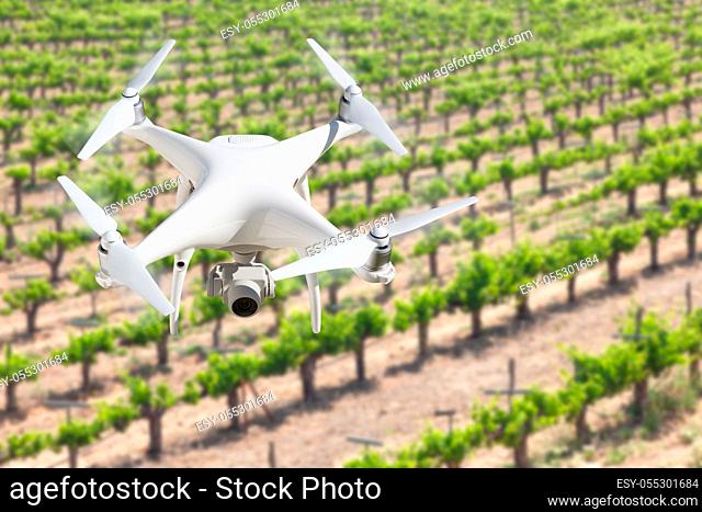 Unmanned Aircraft System (UAV) Quadcopter Drone In The Air Over Grape Vineyard Farm
