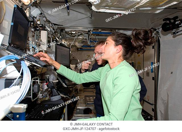 NASA astronaut Nicole Stott and European Space Agency astronaut Frank De Winne, both Expedition 20 flight engineers, work at the Japanese Remote Manipulator...