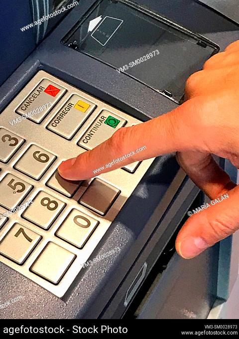 Hand typing secret code in the ATM
