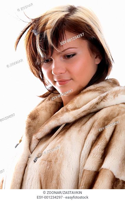 Girl in fur coat on white background