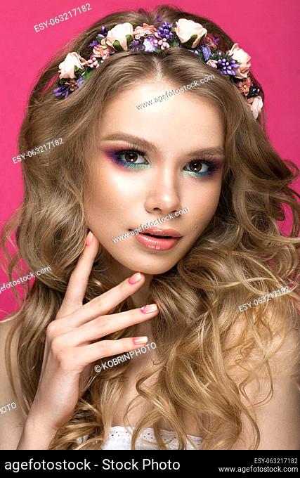 Portrait of a beautiful blond girl in image of the bride with purple flowers on her head. Beauty face. Photo shot in the Studio