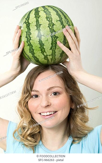Woman balancing watermelon on her head