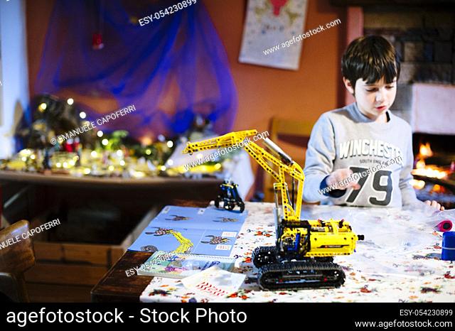 Child builds bulldozer lego