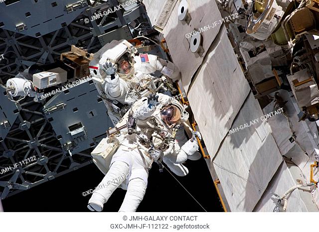 NASA astronauts Steve Bowen and Alvin Drew, both STS-133 mission specialists, participate in the mission's first session of extravehicular activity (EVA) as...