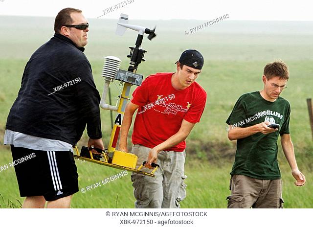 Chris Bowman left, Andrew Arnold middle, and Matthew Rydzik right, recover a torndo pod after a tornado passes in Goshen County, Wyoming, USA, June 5